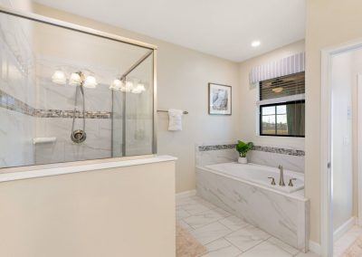 Multigenerational champions gate vacation rental by owner - walk-in shower and soaking tub in primary bathroom